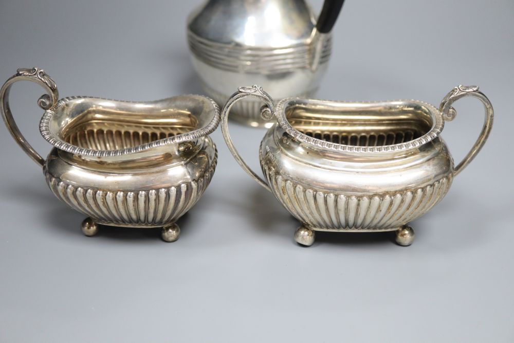 A matched late 19th/early 20th century demi-fluted silver three piece tea set, Sheffield, 1899 & London, 1901, gross 21.5 oz.
